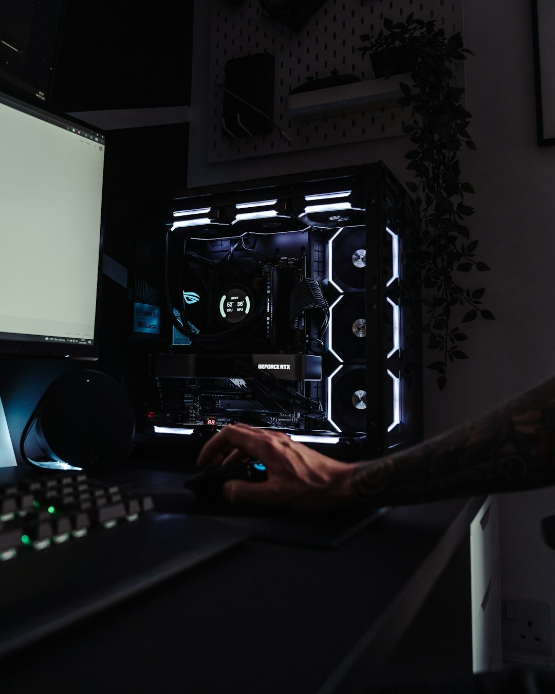 Tattooed hand operating a gaming PC mouse.
