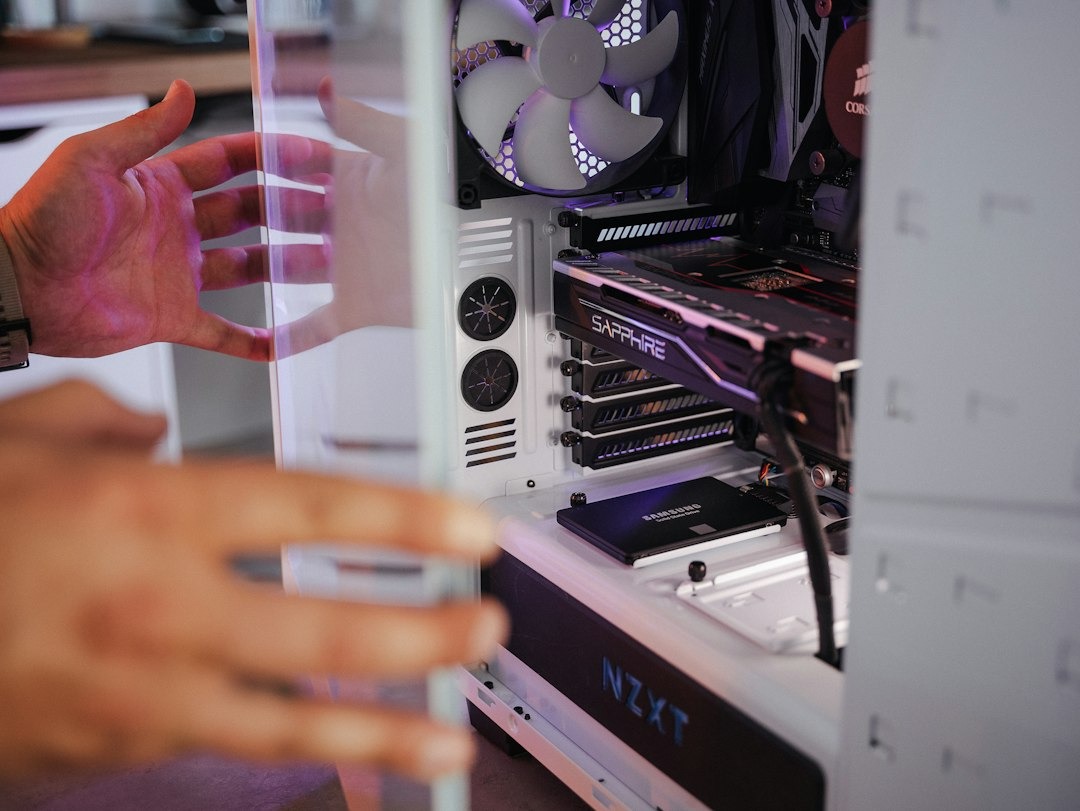 Hands opening the side panel of a desktop computer tower.